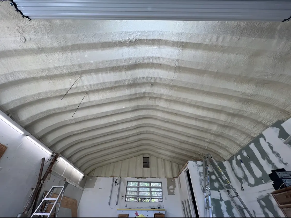 Spray polyurethane foam applied to the underside of a metal roof deck in Maple Grove
